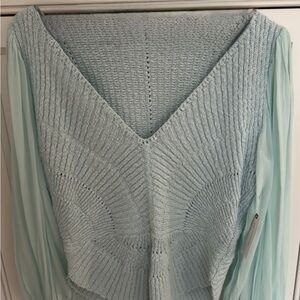 Light green knit sweater never worn features v neck sheer sleeves